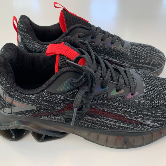 NAIKOYO trail running shoes in black and red colorway showing side profile and tread design